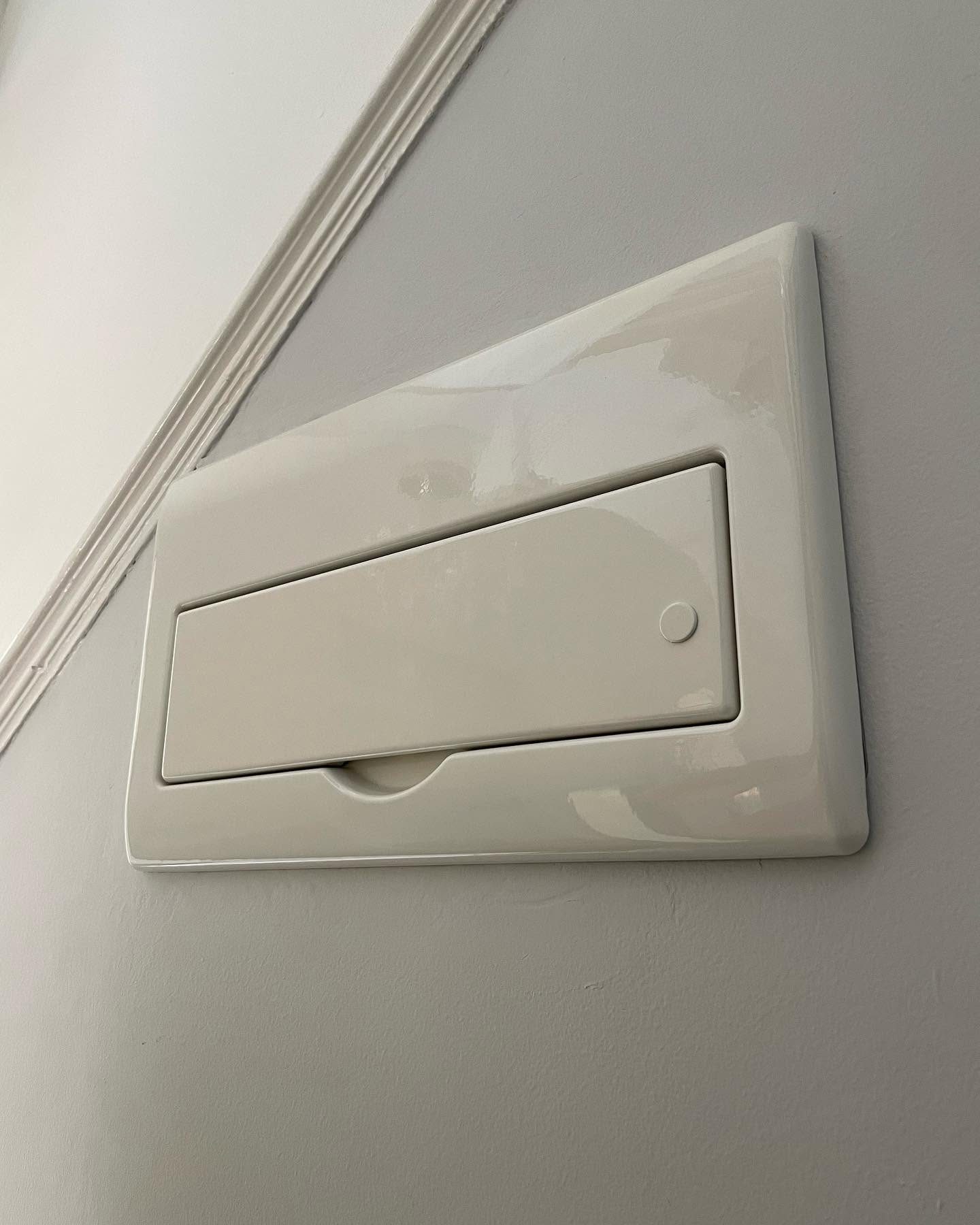 Newly fitted domestic consumer unit with closed cover after a rewire
