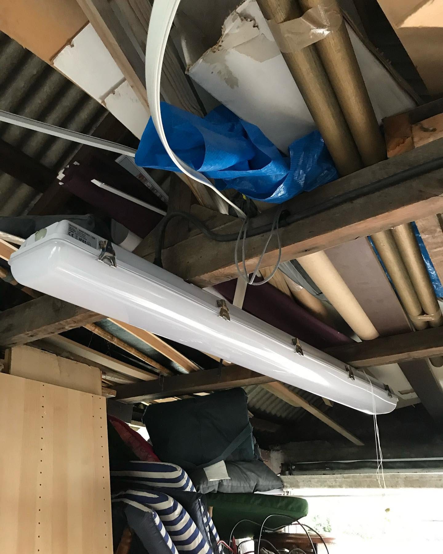 IP65 LED batten light installed on the roof timbers of a garage workshop