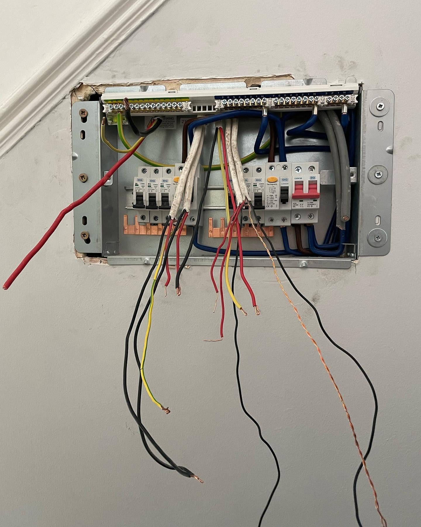 Consumer unit opened for testing with circuit conductors visible