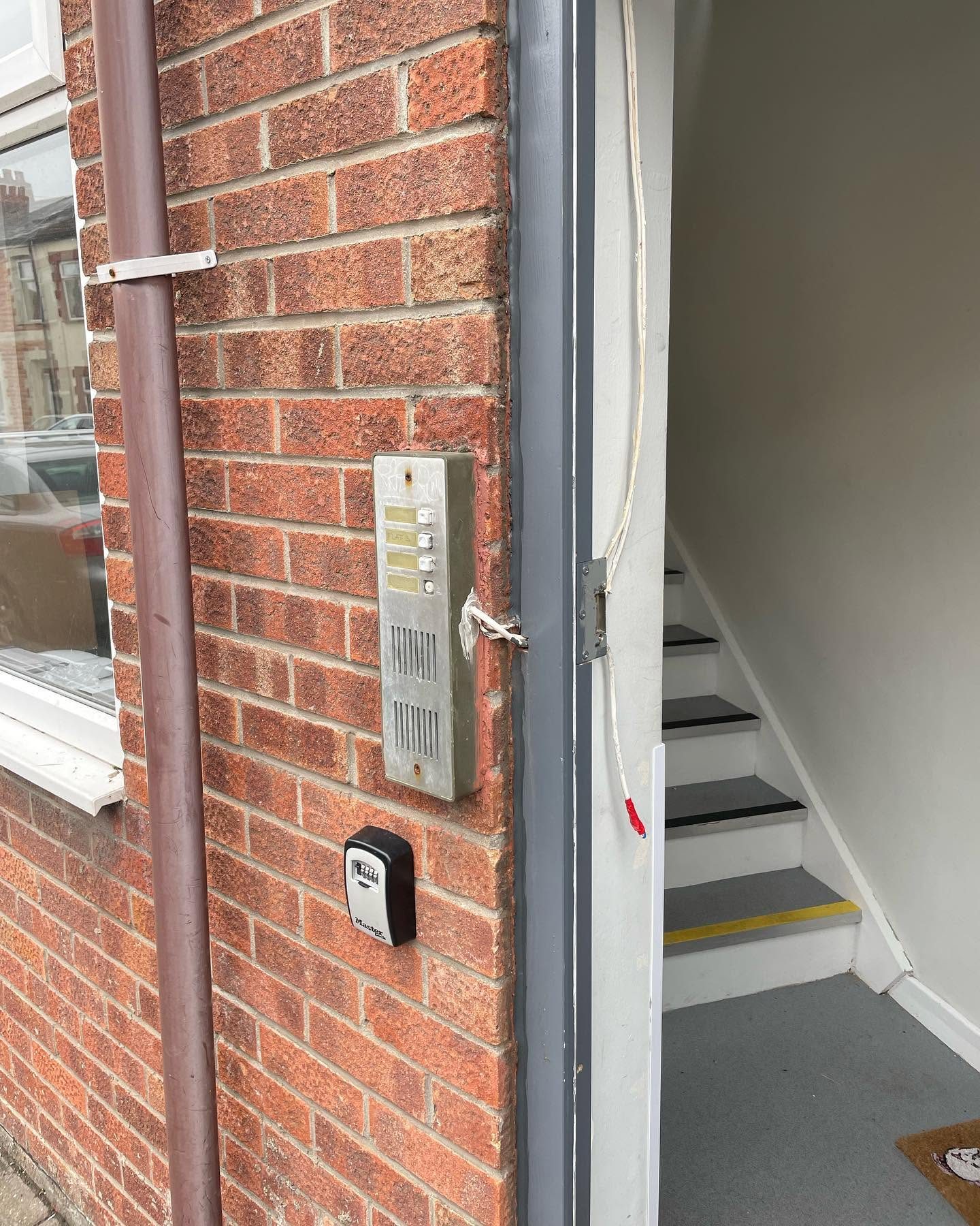 Door entry intercom panel and key safe installed at the entrance to a block of flats