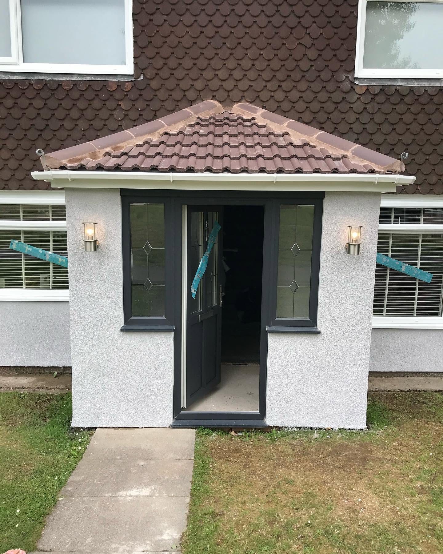 Front entrance of a rendered house after external lighting and power works