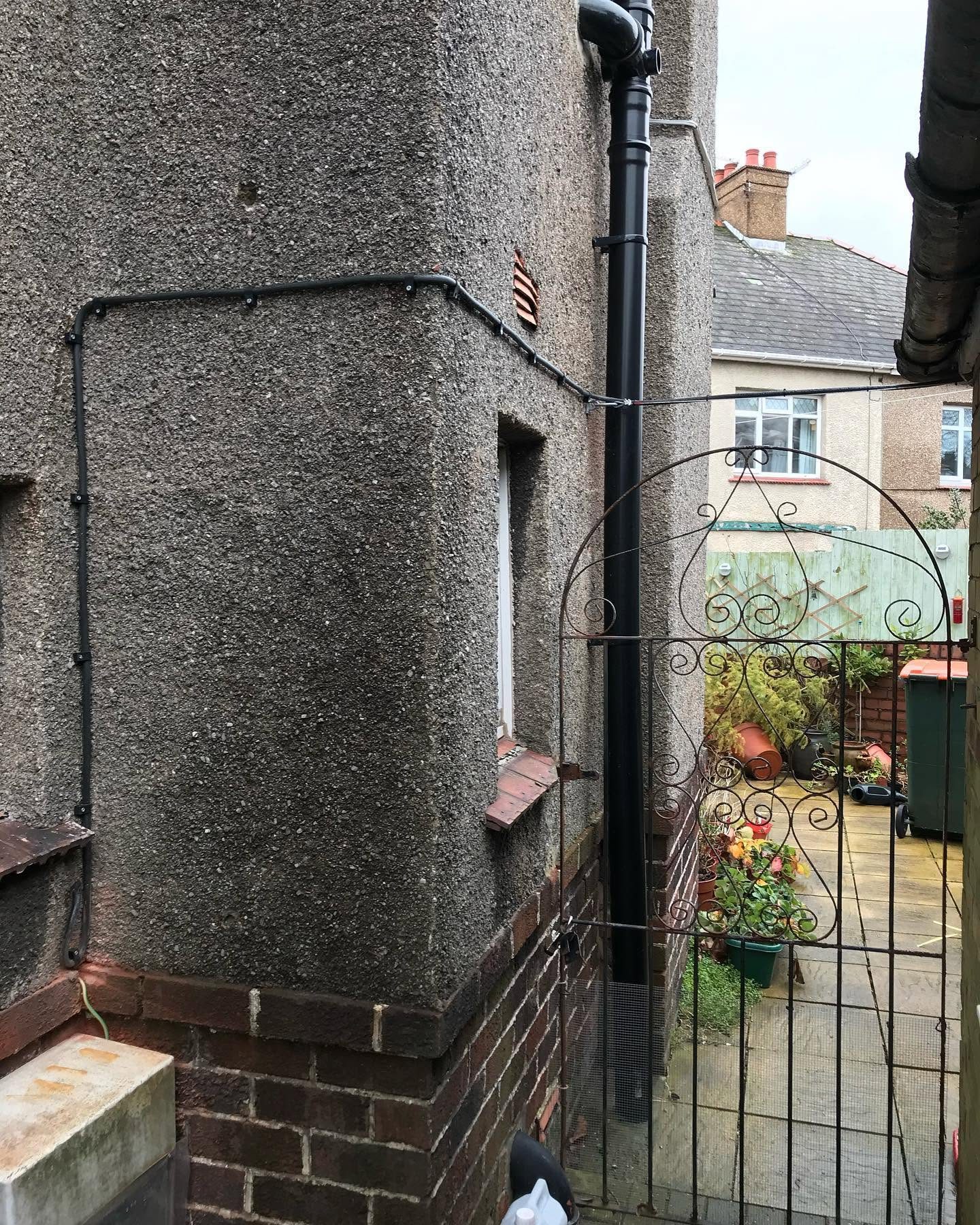 Surface-mounted external cabling run neatly along a side passage wall