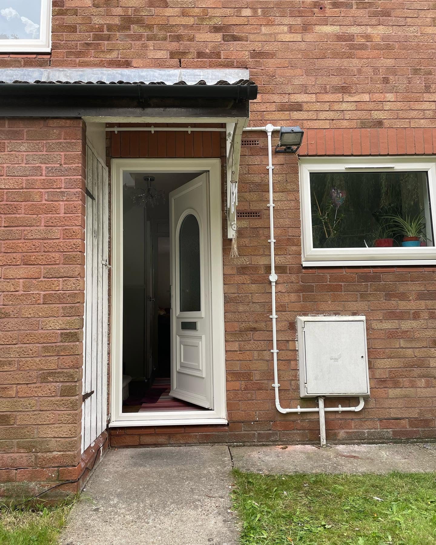 External floodlight, conduit and meter box on a domestic property