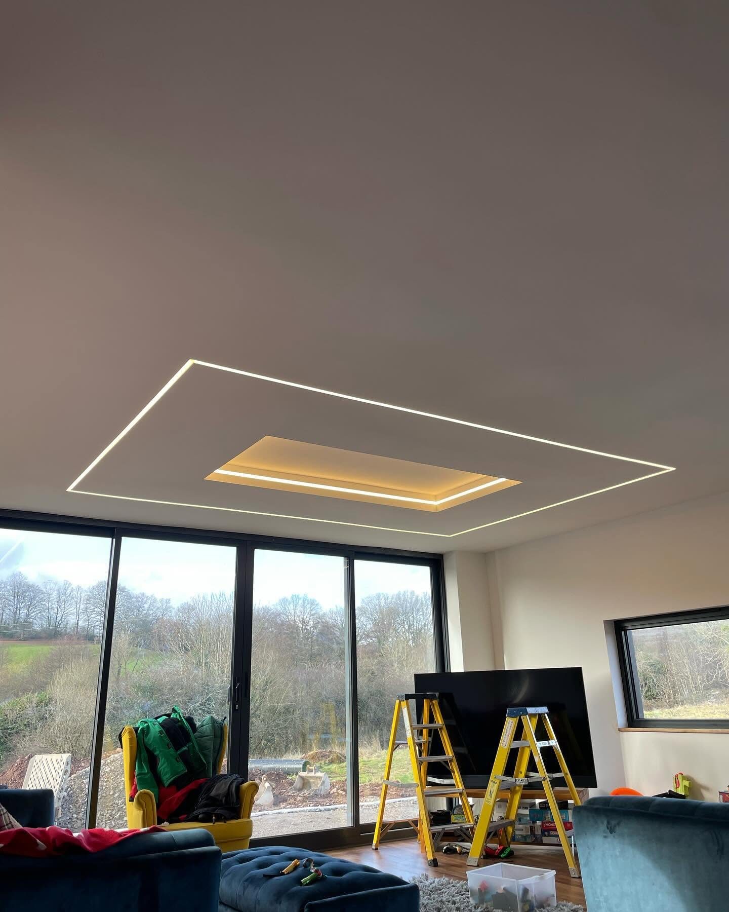 Geometric recessed ceiling lighting installed in a modern living room