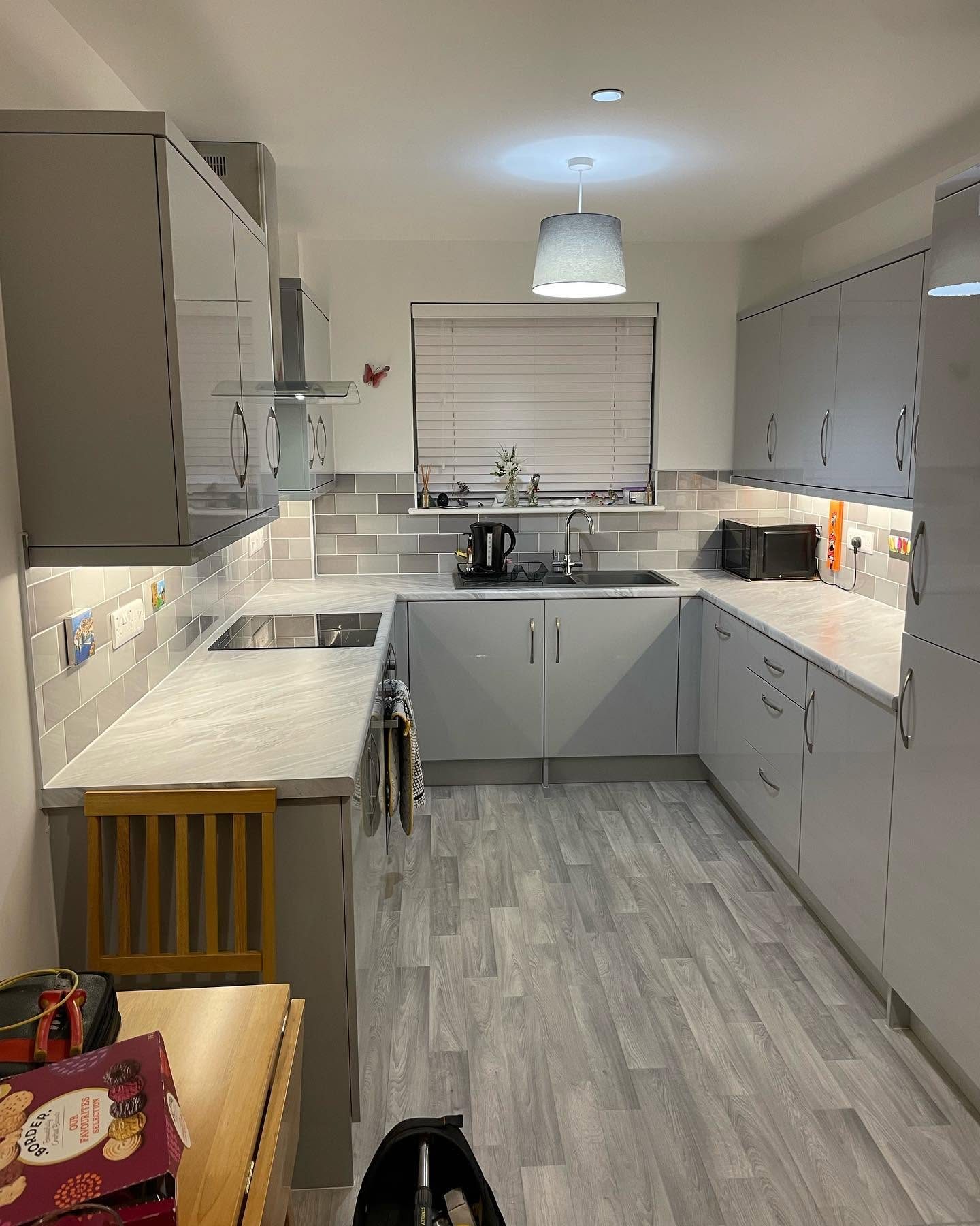 Modern grey kitchen with ceiling and under-cabinet lighting after electrical work