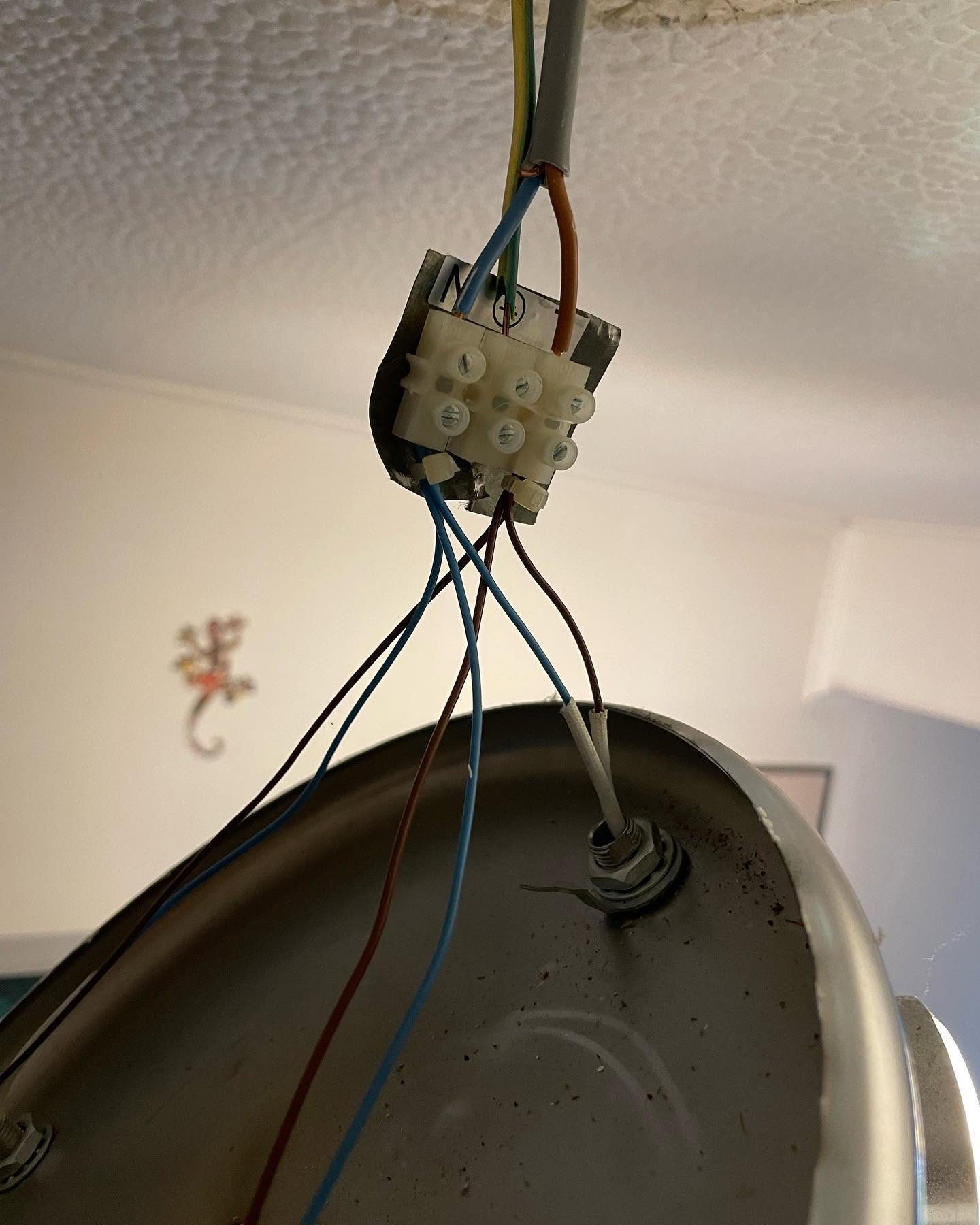 Exposed conductors and terminal block inspected during electrical fault finding