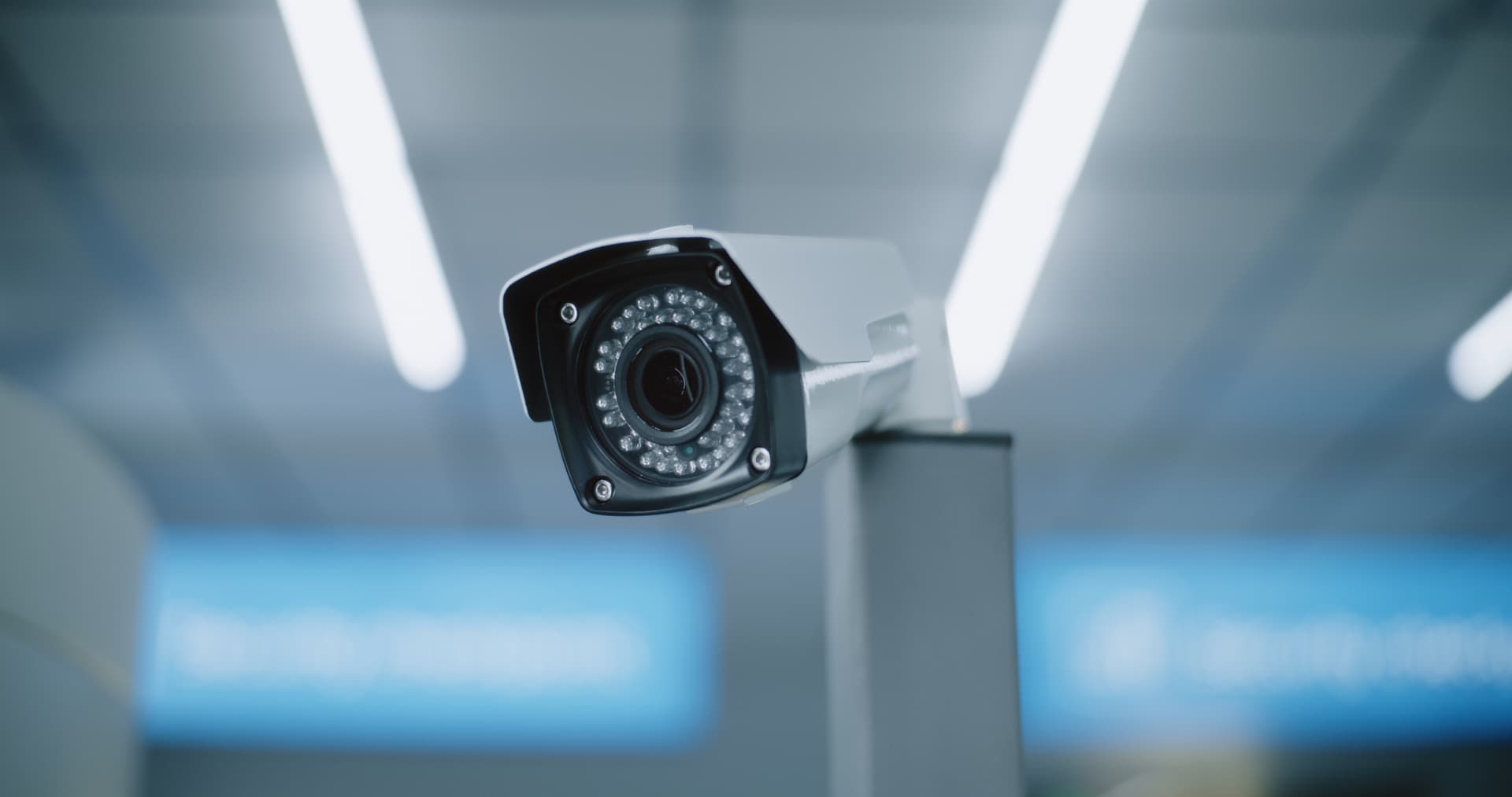 Bullet CCTV camera with infrared LEDs monitoring a commercial interior