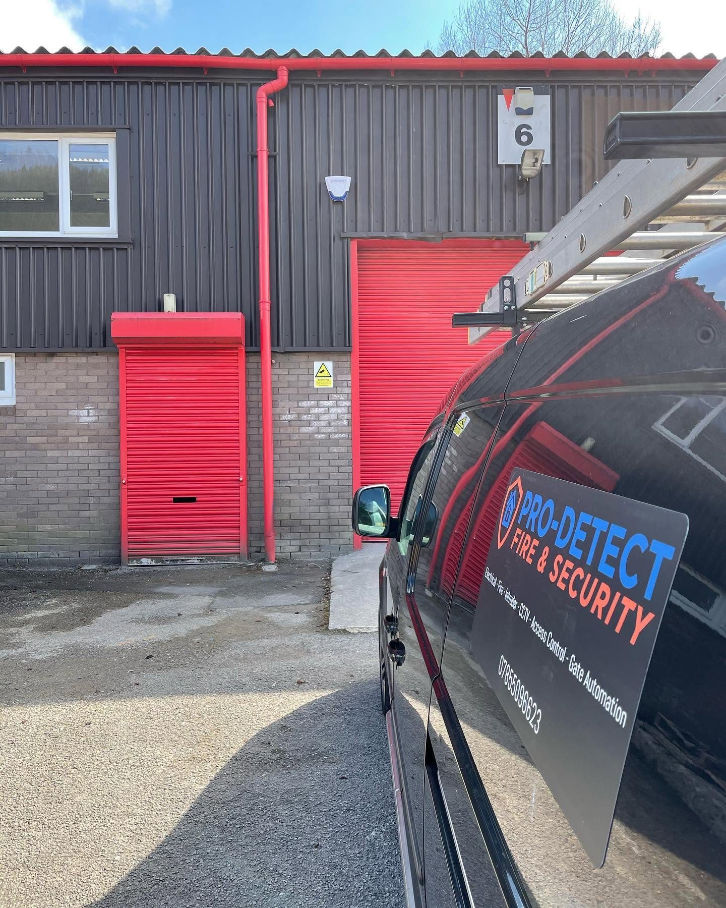 Pro-Detect service van at a commercial unit with an external alarm sounder fitted above the shutters