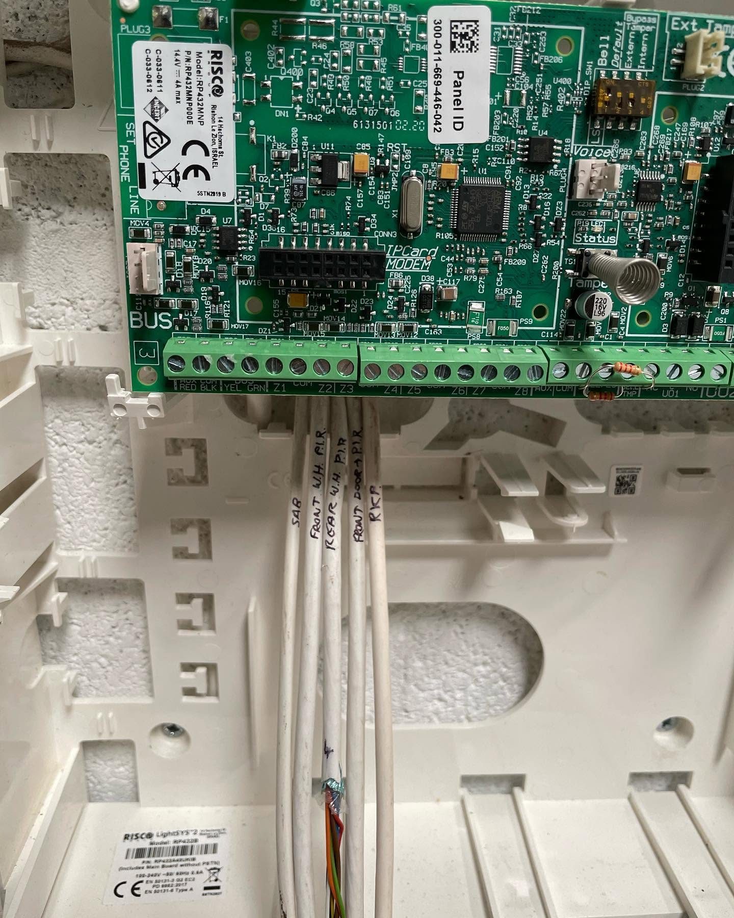 RISCO intruder alarm control board with labelled zone wiring during commissioning